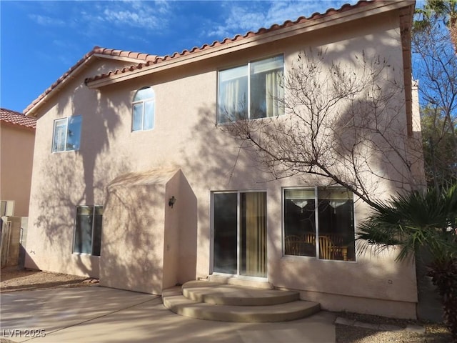 rear view of property featuring a patio area