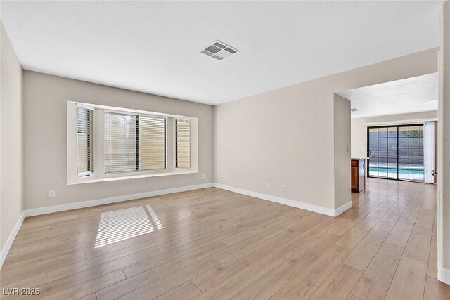 spare room with light hardwood / wood-style flooring