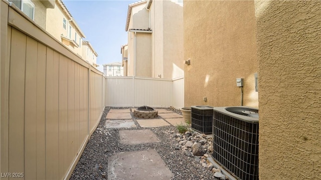 view of patio / terrace with central AC unit and a fire pit