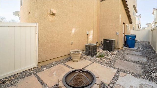 view of patio / terrace featuring cooling unit and an outdoor fire pit