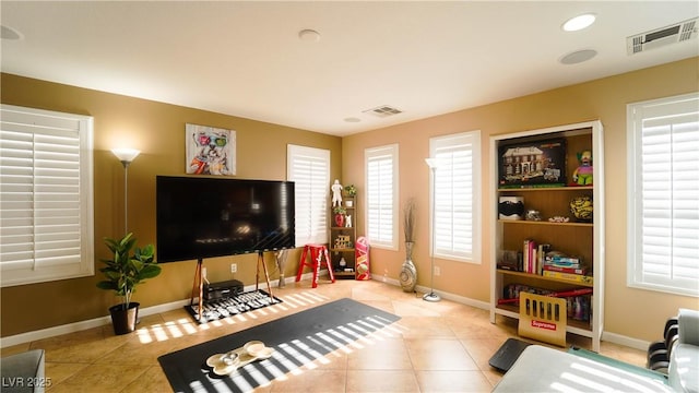 tiled living room featuring a healthy amount of sunlight