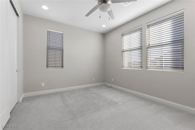 unfurnished room featuring light carpet and ceiling fan