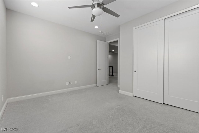 unfurnished bedroom with light carpet, a closet, and ceiling fan