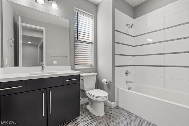 full bathroom with vanity, tile patterned flooring, tiled shower / bath combo, and toilet