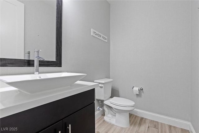 bathroom with vanity, hardwood / wood-style floors, and toilet