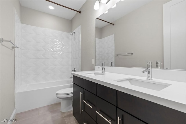 full bathroom with tiled shower / bath combo, vanity, tile patterned floors, and toilet