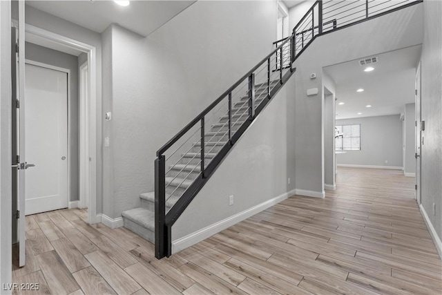 stairway with hardwood / wood-style flooring