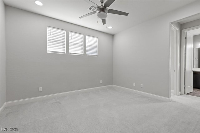 empty room featuring ceiling fan and light carpet