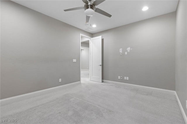 empty room with light colored carpet and ceiling fan