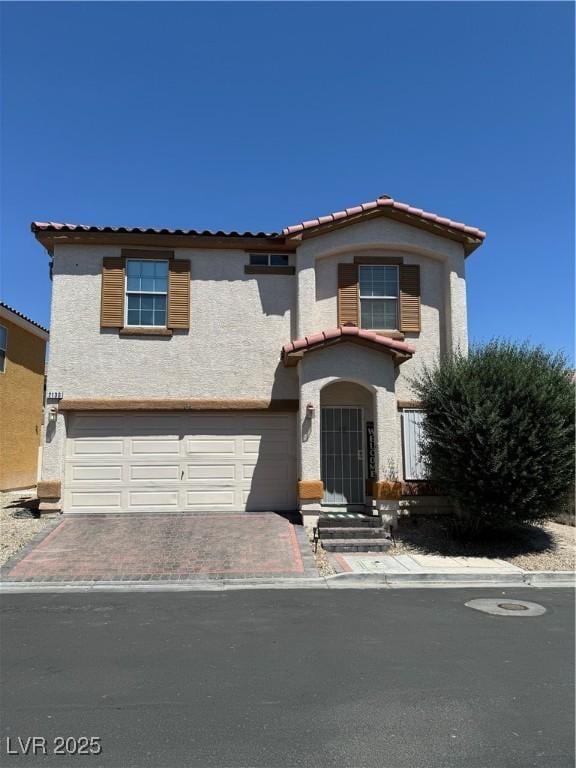 mediterranean / spanish-style home with a garage