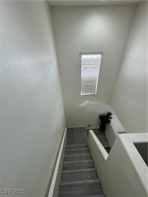 stairs featuring wood-type flooring