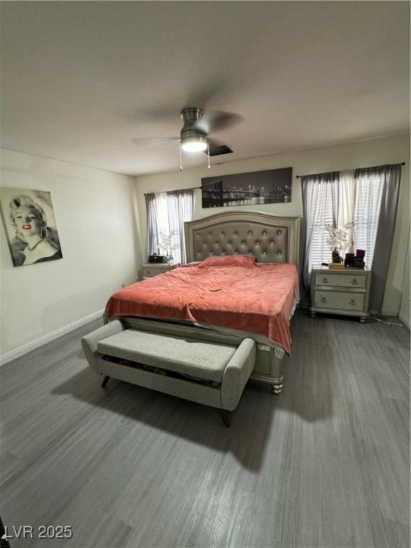 bedroom featuring dark hardwood / wood-style flooring and ceiling fan