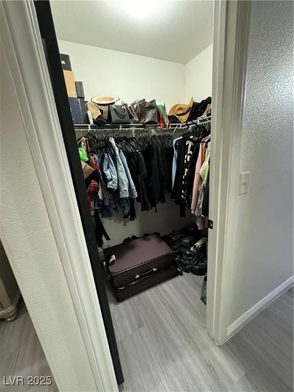 spacious closet featuring hardwood / wood-style floors