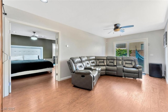 living room with hardwood / wood-style floors and ceiling fan