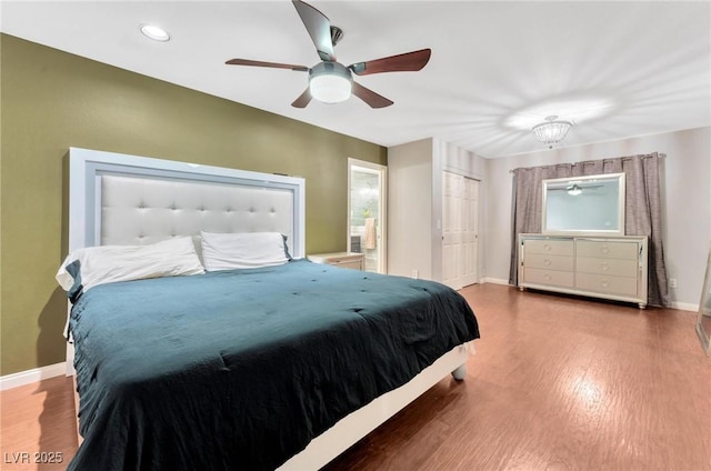 bedroom featuring hardwood / wood-style flooring, ceiling fan, and a closet