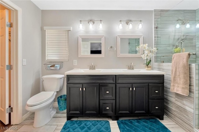 bathroom featuring walk in shower, vanity, and toilet