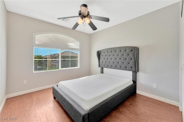 bedroom with hardwood / wood-style flooring and ceiling fan