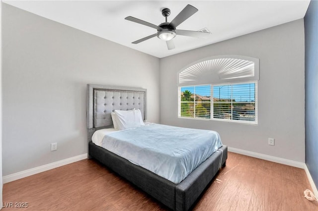 bedroom with wood-type flooring and ceiling fan