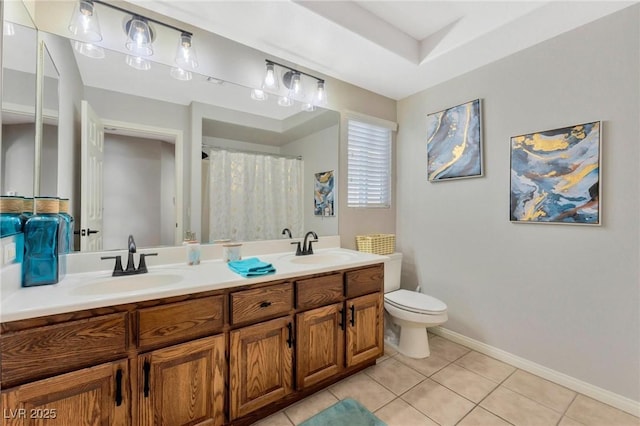 bathroom with vanity, tile patterned flooring, and toilet