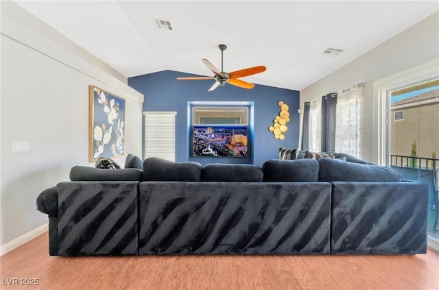 living room featuring lofted ceiling, hardwood / wood-style floors, and ceiling fan