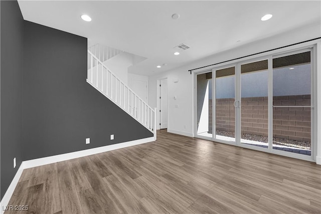 unfurnished living room featuring hardwood / wood-style flooring