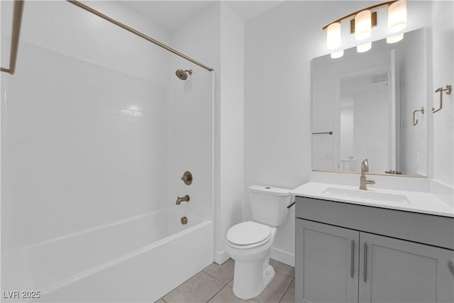 full bathroom with vanity, tiled shower / bath combo, tile patterned floors, and toilet