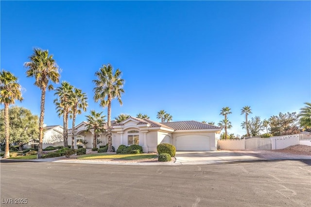 mediterranean / spanish-style home with a garage