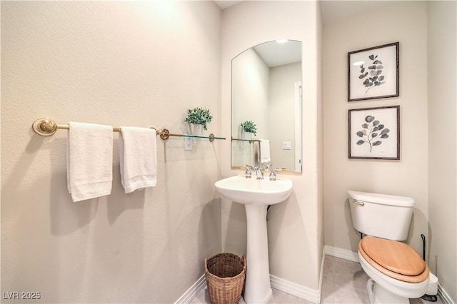 bathroom featuring tile patterned floors and toilet