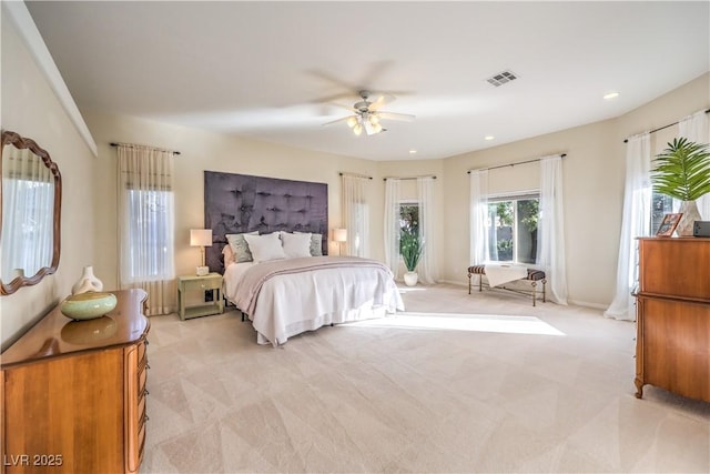 bedroom with ceiling fan and light carpet