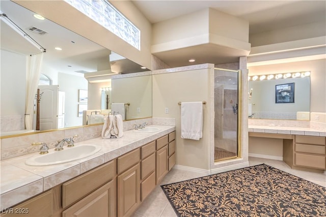 bathroom featuring an enclosed shower, vanity, and tile patterned floors