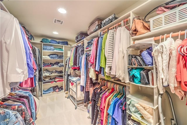 spacious closet with light colored carpet