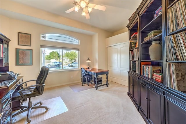 home office featuring ceiling fan and light colored carpet