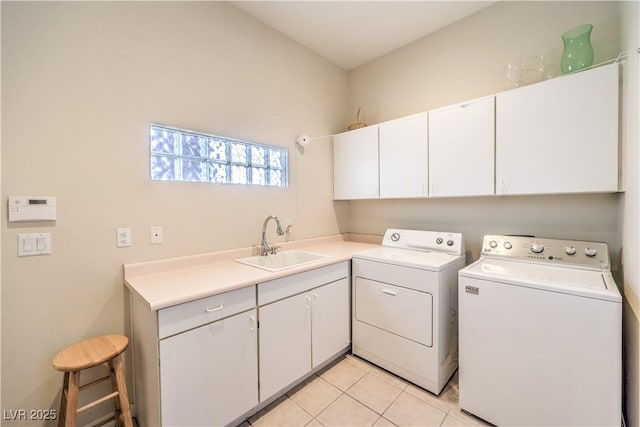 washroom featuring cabinets, sink, washer and dryer, and light tile patterned floors