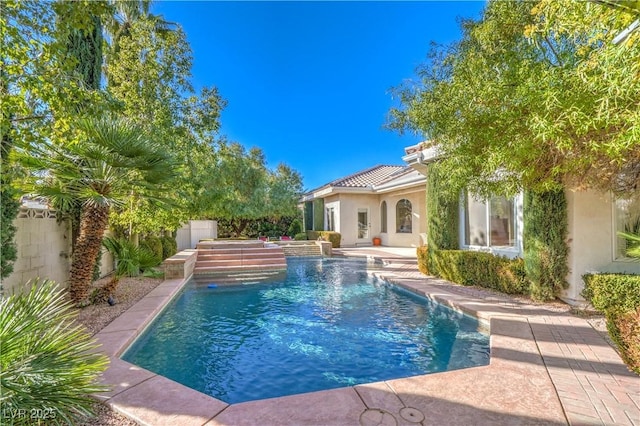 view of swimming pool with pool water feature