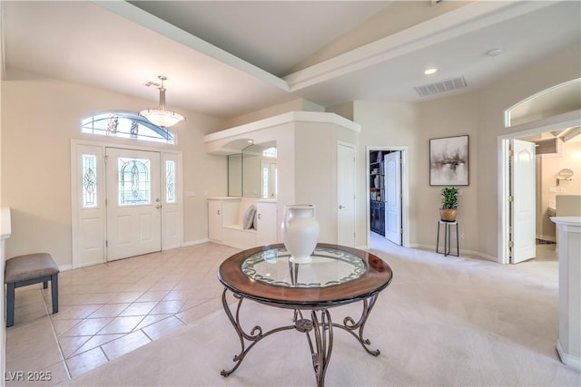 tiled entrance foyer with vaulted ceiling