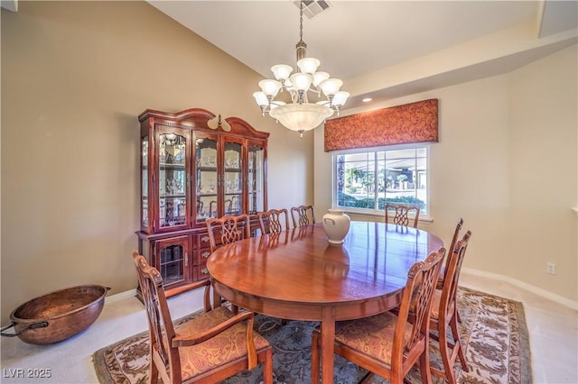 carpeted dining room with an inviting chandelier and vaulted ceiling