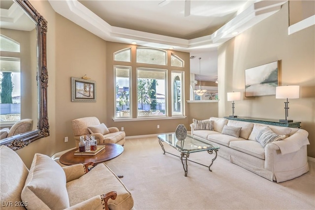 carpeted living room featuring ceiling fan and a tray ceiling