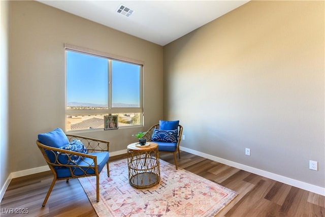 sitting room with hardwood / wood-style flooring