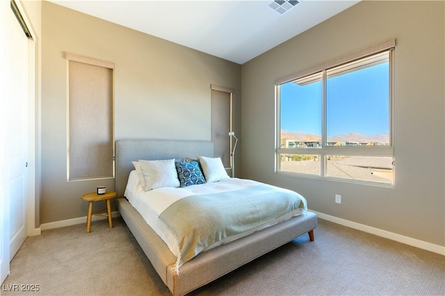 bedroom featuring light colored carpet