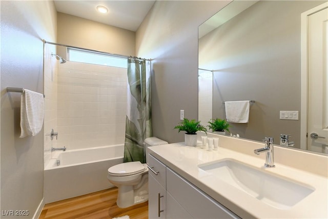 full bathroom featuring vanity, hardwood / wood-style floors, shower / bathtub combination with curtain, and toilet