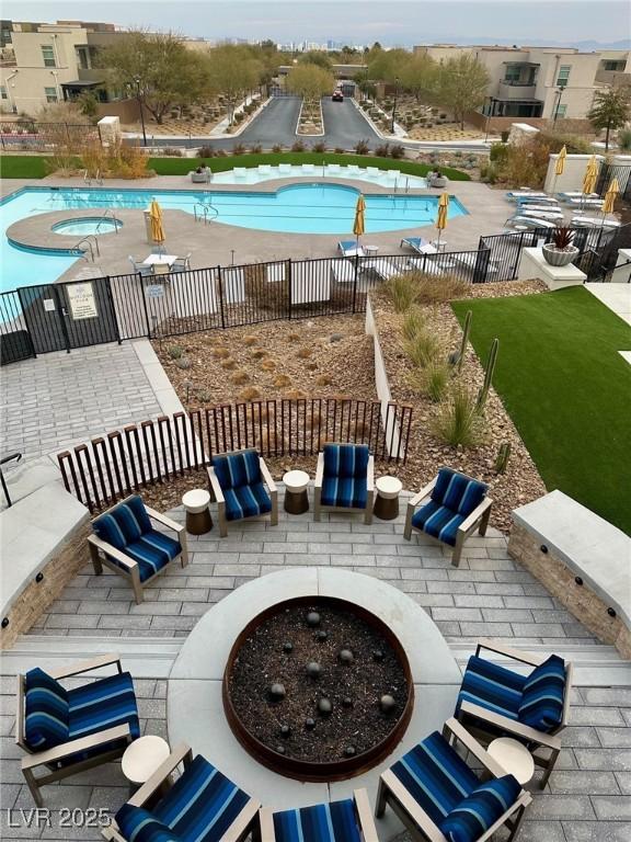 view of swimming pool featuring an outdoor fire pit and a patio area