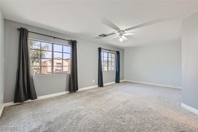 empty room with ceiling fan and carpet