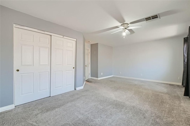 unfurnished bedroom featuring ceiling fan, a closet, and carpet