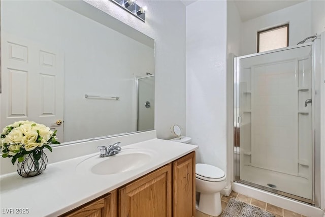 bathroom featuring vanity, toilet, an enclosed shower, and tile patterned flooring