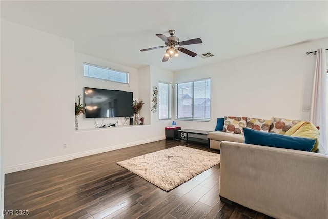 living room with dark wood-type flooring and ceiling fan