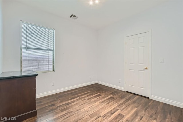 empty room featuring dark wood-type flooring