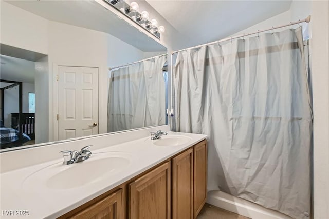 bathroom with walk in shower, lofted ceiling, and vanity