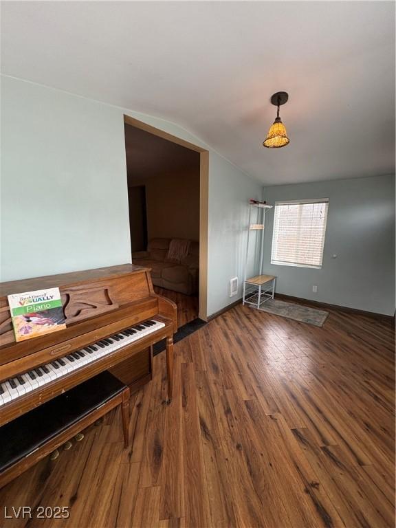 1085 Lyons Ave, Ely, NV 89301 - sitting room featuring vaulted ceiling and wood finished floors