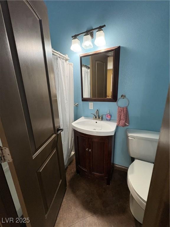 bathroom with vanity, toilet, and tile patterned flooring