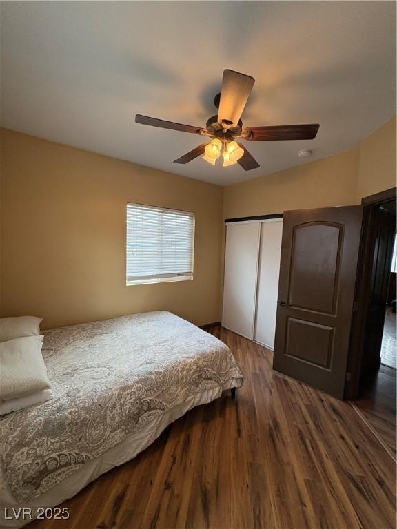 bedroom featuring hardwood / wood-style floors, a closet, and ceiling fan